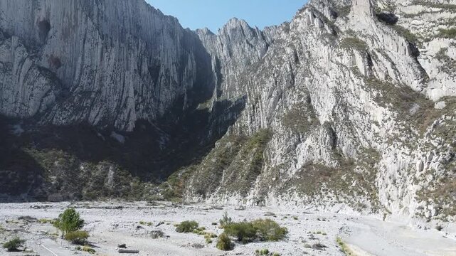 Drone shot of Towering rocky peaks rise above a valley in Huasteca, Nuevo Leon, Mexico