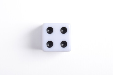One white dice isolated on white background, top view