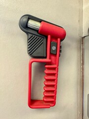 Emergency hammer for breaking glass mounted on the wall inside a passenger train carriage. Safety hammer and emergency equipment in railway transport, used for passenger safety in case of emergency si