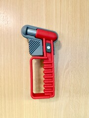 Emergency hammer for breaking glass mounted on the wall inside a passenger train carriage. Safety hammer and emergency equipment in railway transport, used for passenger safety in case of emergency si