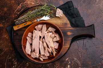 Sustainable tinned tuna fillet in a wooden bowl, promoting eco friendly eating without sacrificing...