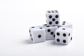 Five white dice on white background, symbolizing luck, chance, probability, and gaming concepts for board games