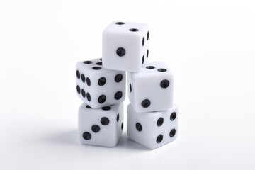 Five white dice on white background, symbolizing luck, chance, probability, and gaming concepts for board games