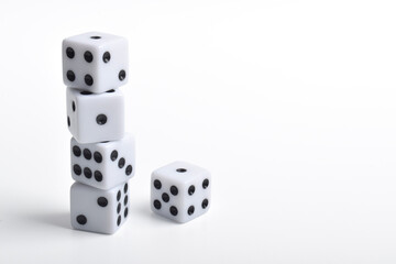 Five white dice on white background, symbolizing luck, chance, probability, and gaming concepts for board games