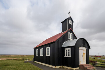 Fototapeta premium Kirkjuvogskirkja, a historic church dated in 1861 in the small village Hafnir on the Reykjanes Peninsula in iceland