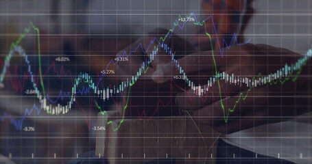 Reviewing data professional man using smartphone at wooden desk with financial charts, copy space