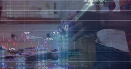 Holding virtual reality headset, man wearing red plaid shirt in home office, with DSLR camera