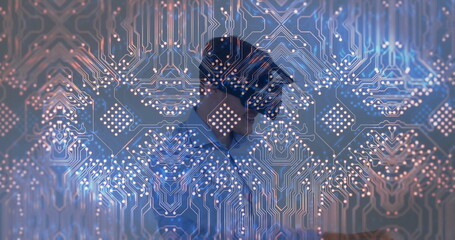 Standing man wearing suit and tie behind translucent panel in office, with glowing circuit pattern