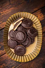 Steel plate with  Jaffa Cookies covered with chocolate and filled with jam. Wooden background. top view