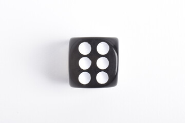 One black dice isolated on white background, top view