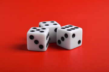 Three dices isolated on red background