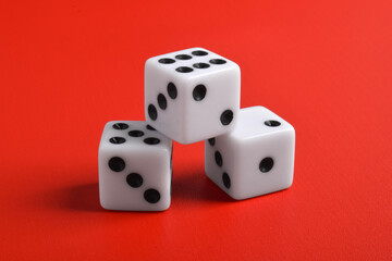 Three dices isolated on red background