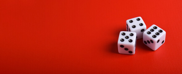 Three dices isolated on red background with copy space for text