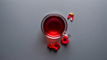 Glass Cup with Deep Red Hibiscus Tea and Petals