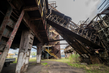 Naklejka premium Abandoned Heavy Industrial Ruins with Large Blast Furnace in Steelworks