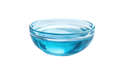 Clear glass bowl holds bright blue liquid, reflecting light for an engaging effect on a neutral surface