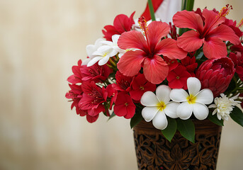 An arrangement of vibrant red hibiscus, red chrysanthemums, and white plumeria flowers in a carved wooden vase against a neutral background.