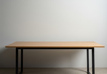 A minimalist wooden desk against a white wall.

