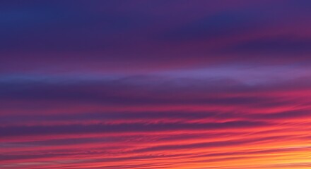A vibrant sunset with streaky purple and pink clouds.

