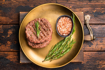 BBQ roasted hamburger chopped meat steaks patties with rosemary. wooden background. top view