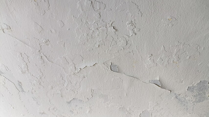 Fractured cement wall texture with horizontal orientation showing damaged concrete, worn finish,...