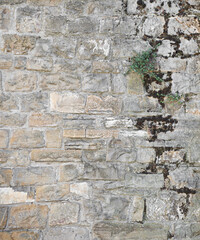 Stone wall of old construction with parts dirty