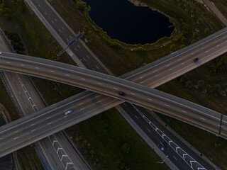 Aerial view of ribbons of concrete interweave, connecting distant points as vehicles traverse the overpasses of the highway system at Sawgrass Interchange, Sunrise, Florida, United States.