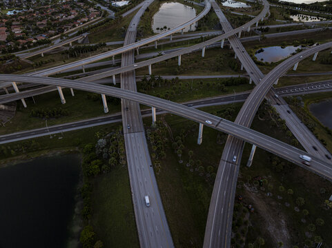 Aerial view of the complex sawgrass interchange system with multiple overpasses and connecting ramps, a concrete tapestry woven above the landscape, Sunrise, Florida, United States.