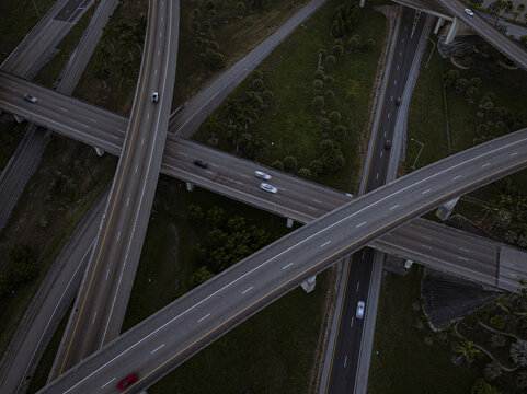 Aerial view of the intricate sawgrass highway interchange weaving through patches of green, a concrete tapestry under the soft light, Sunrise, Florida, United States.
