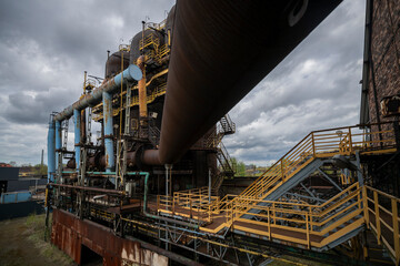 Fototapeta premium Abandoned Heavy Industrial Ruins with Large Blast Furnace in Steelworks