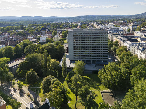 Aerial view of the Radisson Blu Plaza Hotel stands tall amid lush greenery, contrasting with the urban landscape, Oslo, Oslo, Norway.