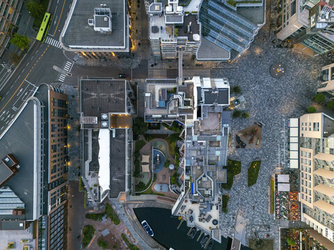 Aerial view of modern architectural buildings meet the waterfront, the cobblestone streets glistening under the soft light, Aker Brygge, Oslo, Oslo, Norway.