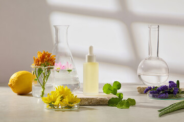 Serum bottle and herbal ingredients including lemon, marigold, butterfly pea, and fresh leaves arranged with glass labware on reflective surface. Balanced shadow and soft light setup.VN Mô tả: