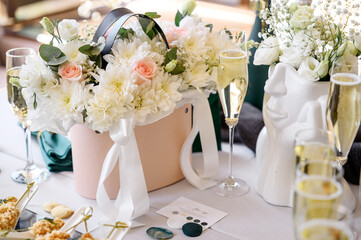 a lot of wedding rings and a bouquet of different flowers on a white plate
