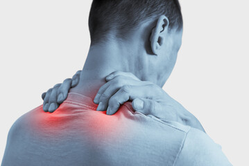 Young man suffering from backache, painful area highlighted in red. Grayscale photo of man with...