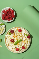 fresh cauliflower salad with dor blue cheese and raspberries