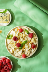 fresh cauliflower salad with dor blue cheese and raspberries