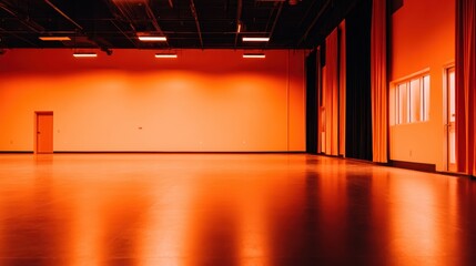 Spacious orange room with polished floor and large windows, ideal for events and gatherings