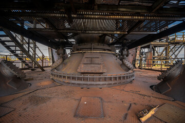 Obraz premium Abandoned Heavy Industrial Ruins with Large Blast Furnace in Steelworks