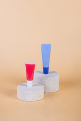 Purple packaging for cream, sunscreen or serum on with stylish props on cream background.