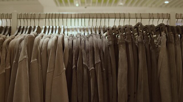 Brown clothing on hangers in fashion store