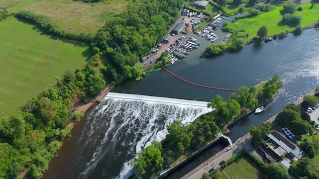 Aerial drone footage of Gunthorpe weir River Trent water control and narrow boats in harbour green rural landscape Nottingham England UK Europe 