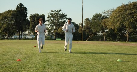 Finishing lap around cones, Diverse male duo shaking hands, exchanging tips on sports field