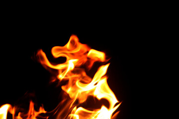 Close up burning flames on black background for graphic design or wallpaper.
