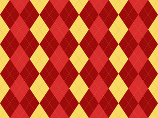 Fototapeta premium Vibrant red and yellow argyle pattern. Perfect for backgrounds, textiles, or website design. This classic diamond design offers a stylish and sophisticated look, conveying energy and tradition.