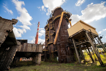 Fototapeta premium Abandoned Heavy Industrial Ruins with Large Blast Furnace in Steelworks