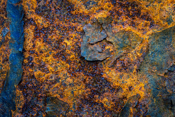 Rusty metal surface with shabby background paint. Blue cracked paint texture on an iron sheet. Fragment of an old metal door, Metal corrosion.