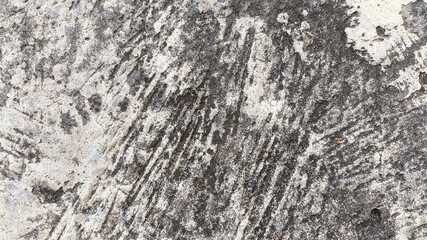 Cracked and dirty cement wall with erosion marks and surface wear. Grunge style for damaged architecture textures.