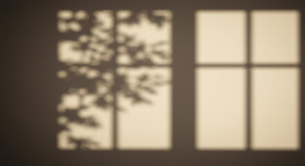 Shadows of a window and tree branches cast on a wall creating a soft and blurred abstract pattern