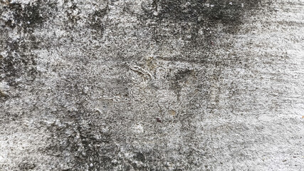 Damaged wall surface with rough cracks and dirt. Concrete texture suitable for architecture and...